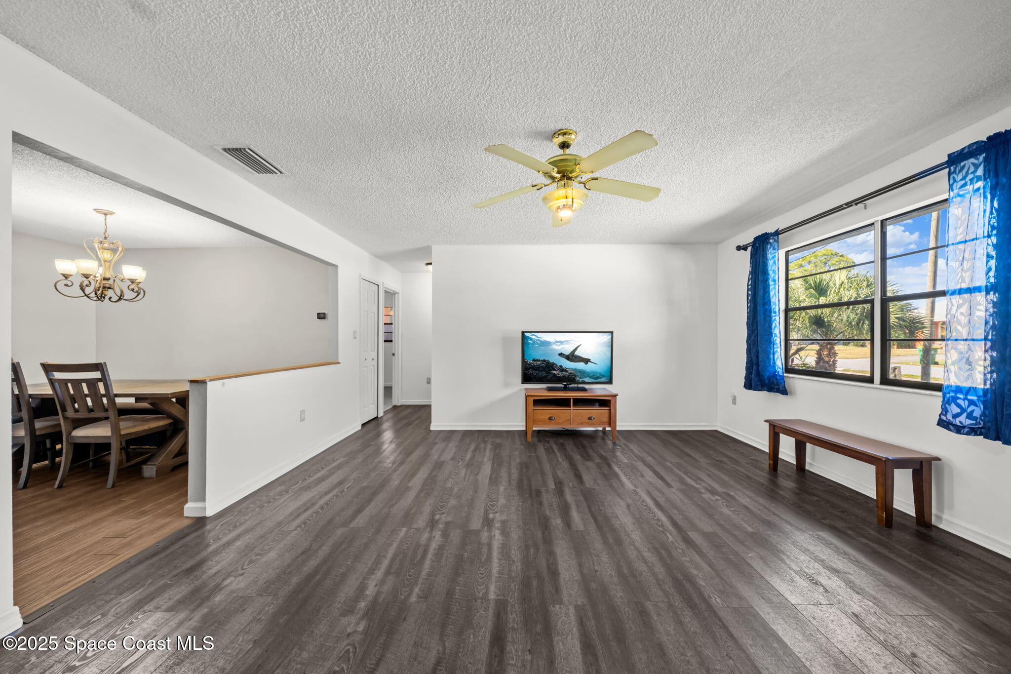 4257 Piedras Street Cocoa, FL 32927 - Photo 4 of 23 a view of an empty room with a window and wooden floor