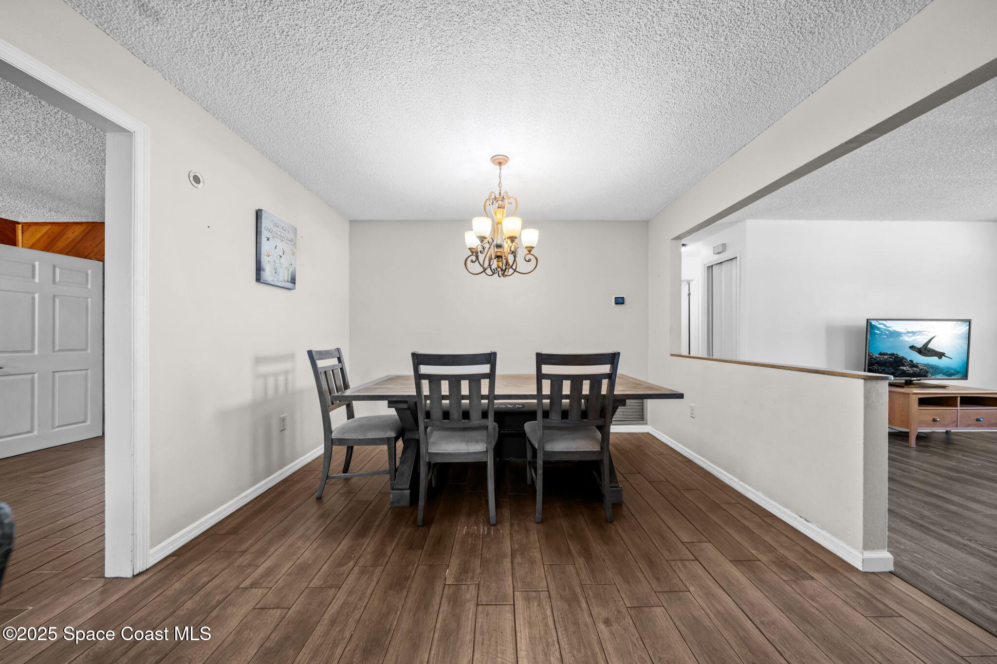 4257 Piedras Street Cocoa, FL 32927 - Photo 6 of 23 a dining room with furniture a chandelier and wooden floor