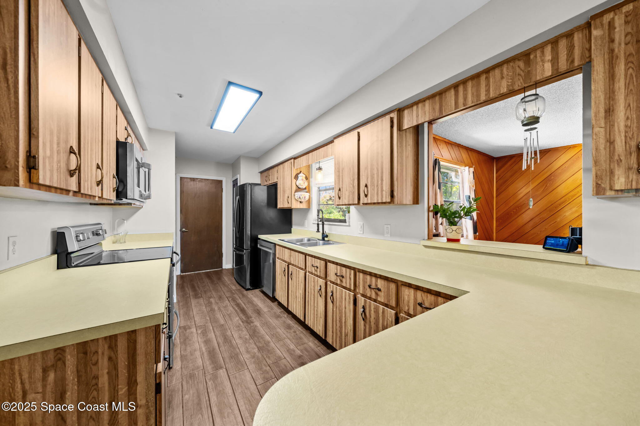 4257 Piedras Street Cocoa, FL 32927 - Photo 7 of 23 a kitchen with stainless steel appliances granite countertop a sink a stove and a refrigerator