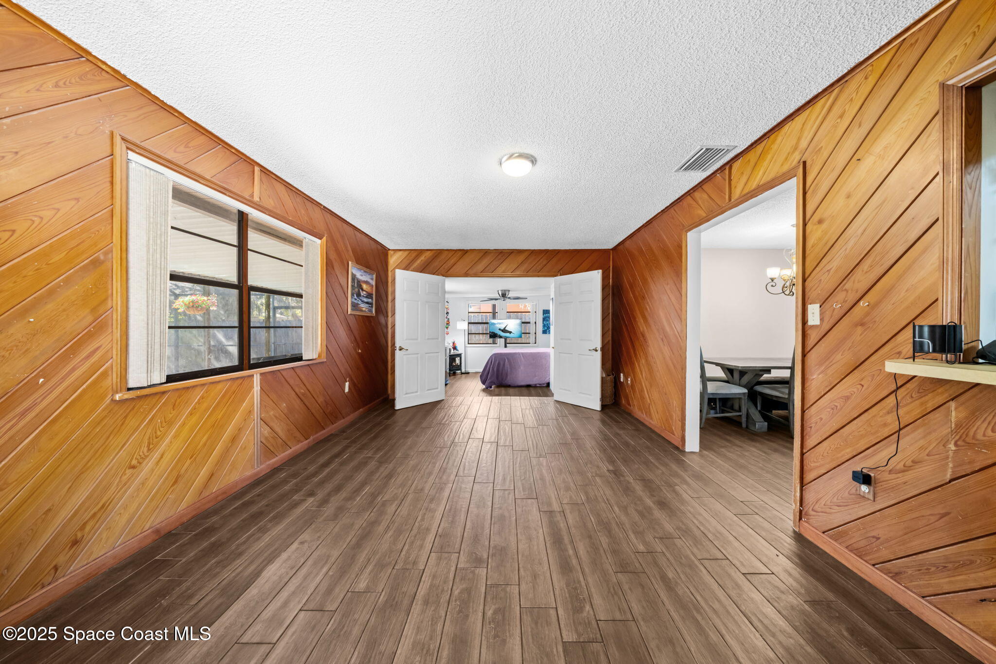 4257 Piedras Street Cocoa, FL 32927 - Photo 8 of 23 a view of a hallway with wooden floor and furniture