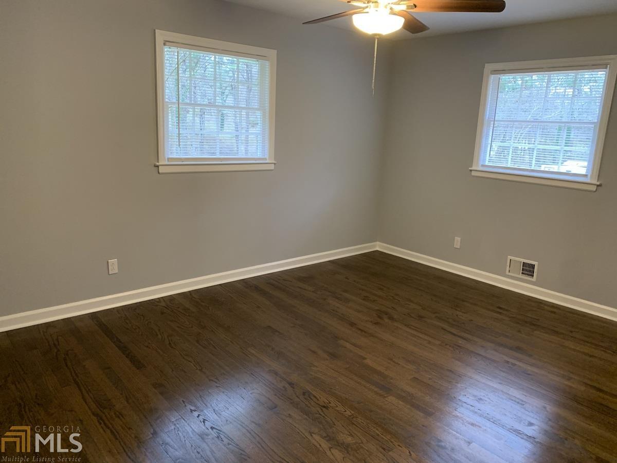 2386 Miriam Lane Decatur, GA 30032 - Photo 11 of 20 a view of an empty room with wooden floor and a window