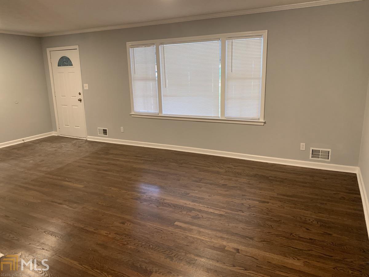 2386 Miriam Lane Decatur, GA 30032 - Photo 2 of 20 a view of an empty room with wooden floor and a window