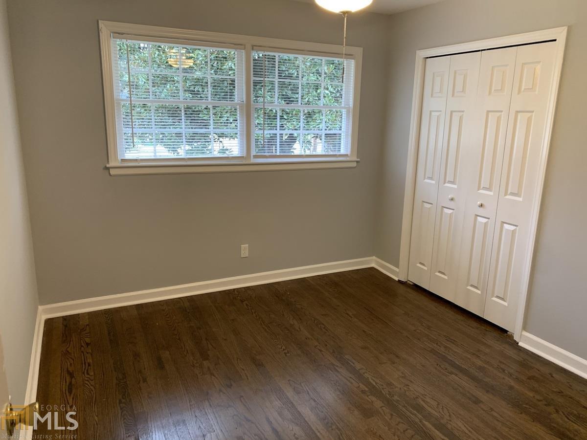 2386 Miriam Lane Decatur, GA 30032 - Photo 9 of 20 an empty room with wooden floor and windows