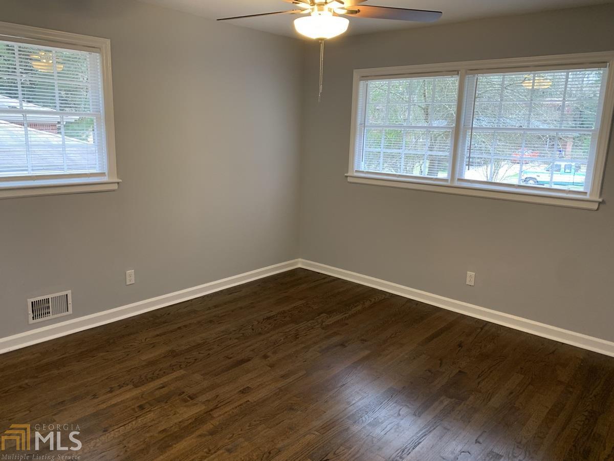 2386 Miriam Lane Decatur, GA 30032 - Photo 10 of 20 a view of an empty room with wooden floor and a window