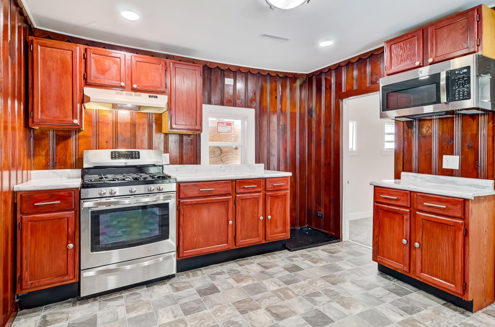 246 142nd Street Hammond, IN 46327 - Photo 22 of 30 a kitchen with stainless steel appliances granite countertop wooden cabinets a stove top oven and granite countertops