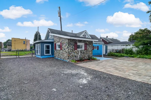 a view of a house with a yard and plants