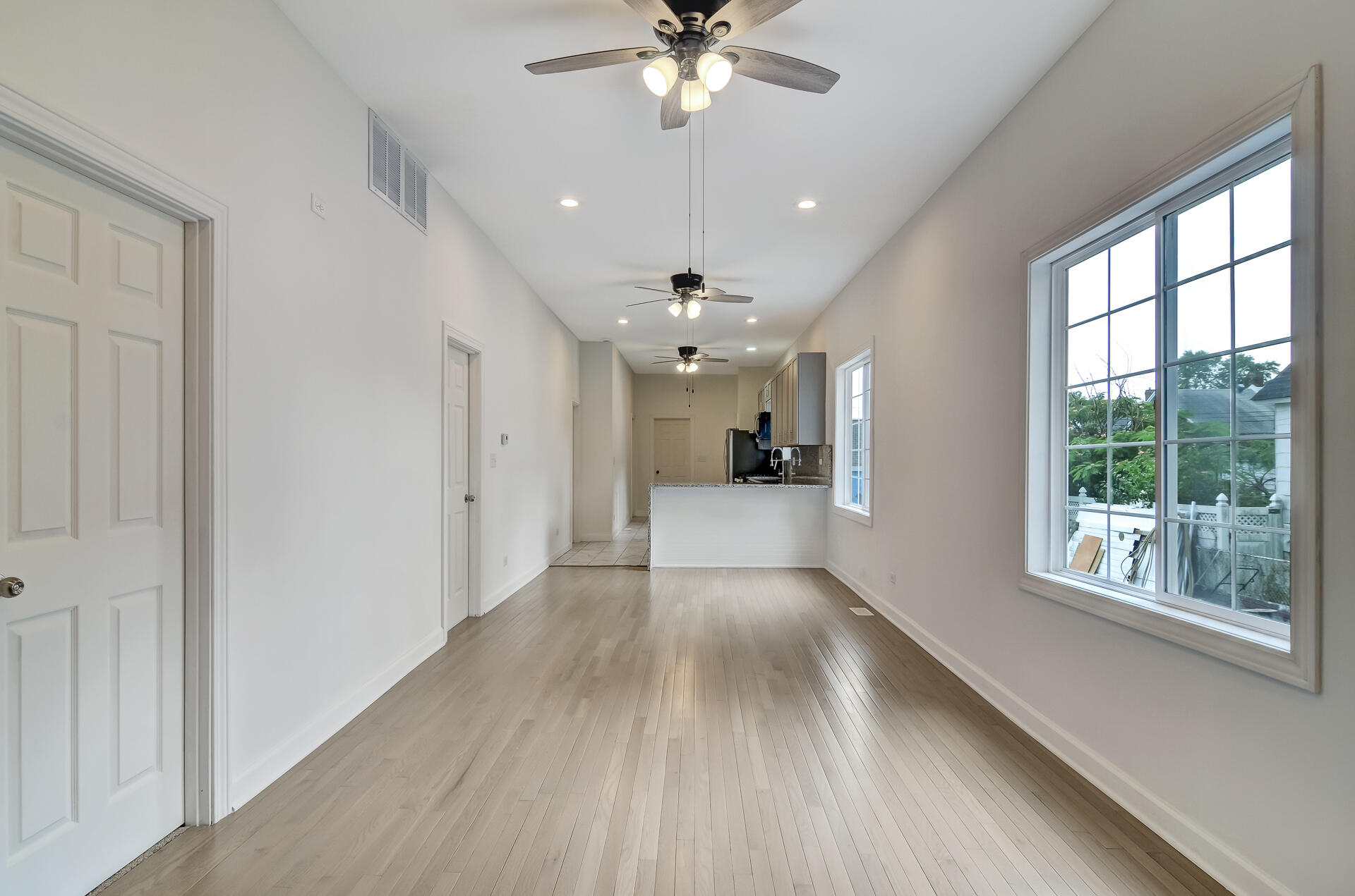 246 142nd Street Hammond, IN 46327 - Photo 8 of 30 a view of a livingroom with a ceiling fan window hardwood floor and leading from a corridor