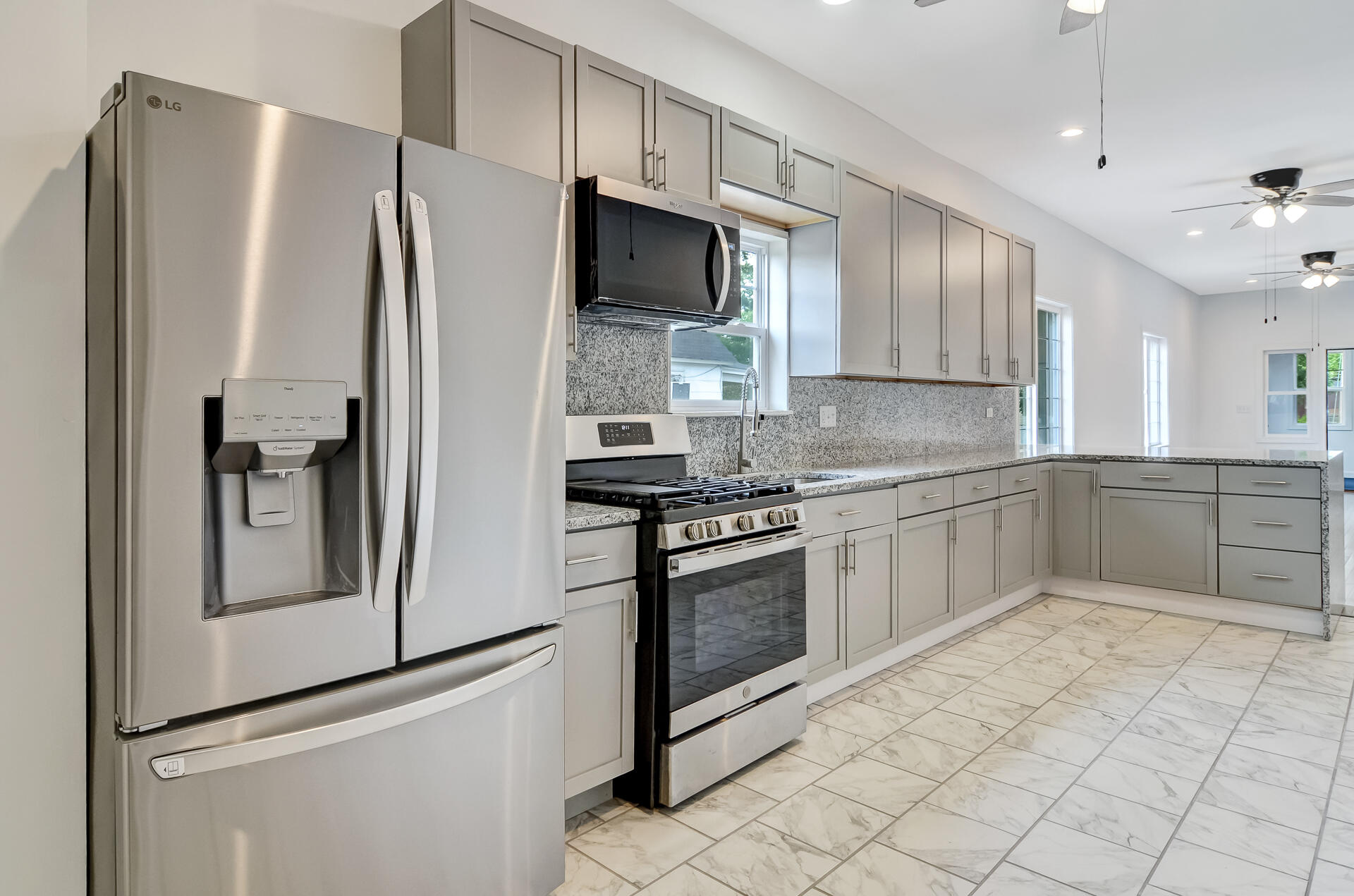 246 142nd Street Hammond, IN 46327 - Photo 10 of 30 a kitchen with stainless steel appliances granite countertop a refrigerator a stove a sink and a microwave