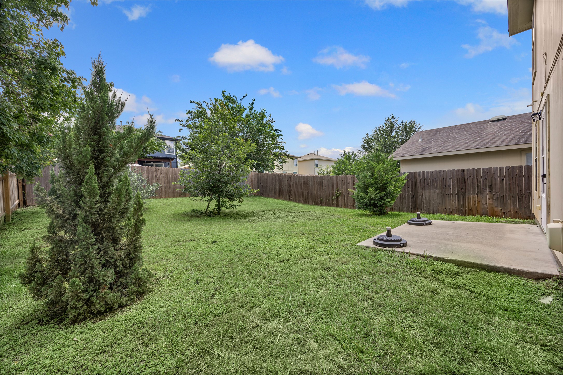 198 Black Forest Road Buda, TX 78610 - Photo 20 of 23 An ample backyard provides both a lush lawn and a practical concrete patio for outdoor enjoyment.