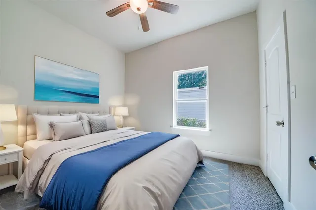 a bedroom with a large bed and a window