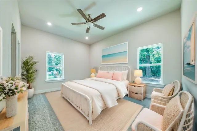 a bedroom with a large bed chandelier and a window