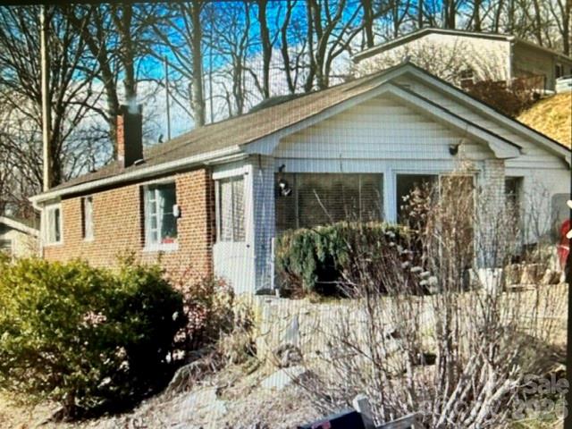 10200 Highway 23 Cheboygan, MI 49721 - Photo 2 of 4 a front view of a house with a yard and fountain
