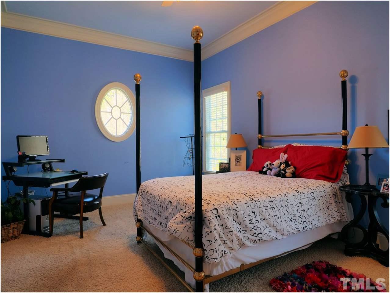 3408 Ocotea Street Raleigh, NC 27607 - Photo 15 of 25 a bedroom with a bed and a table in it