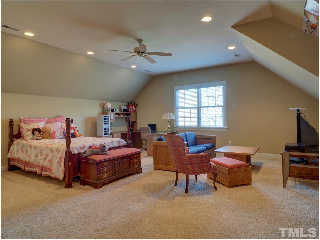 3408 Ocotea Street Raleigh, NC 27607 - Photo 17 of 25 a living room with furniture a flat screen tv and a window