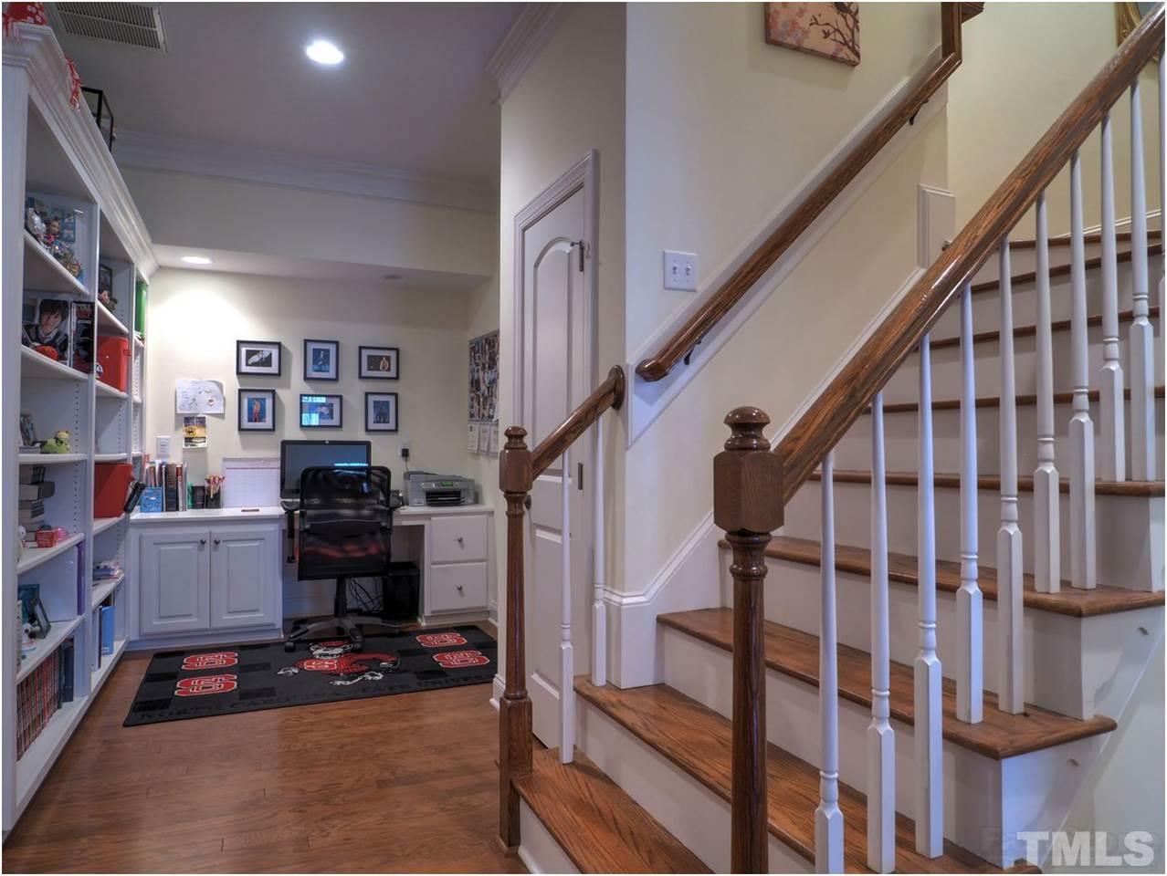 3408 Ocotea Street Raleigh, NC 27607 - Photo 20 of 25 a living room with furniture and stairs