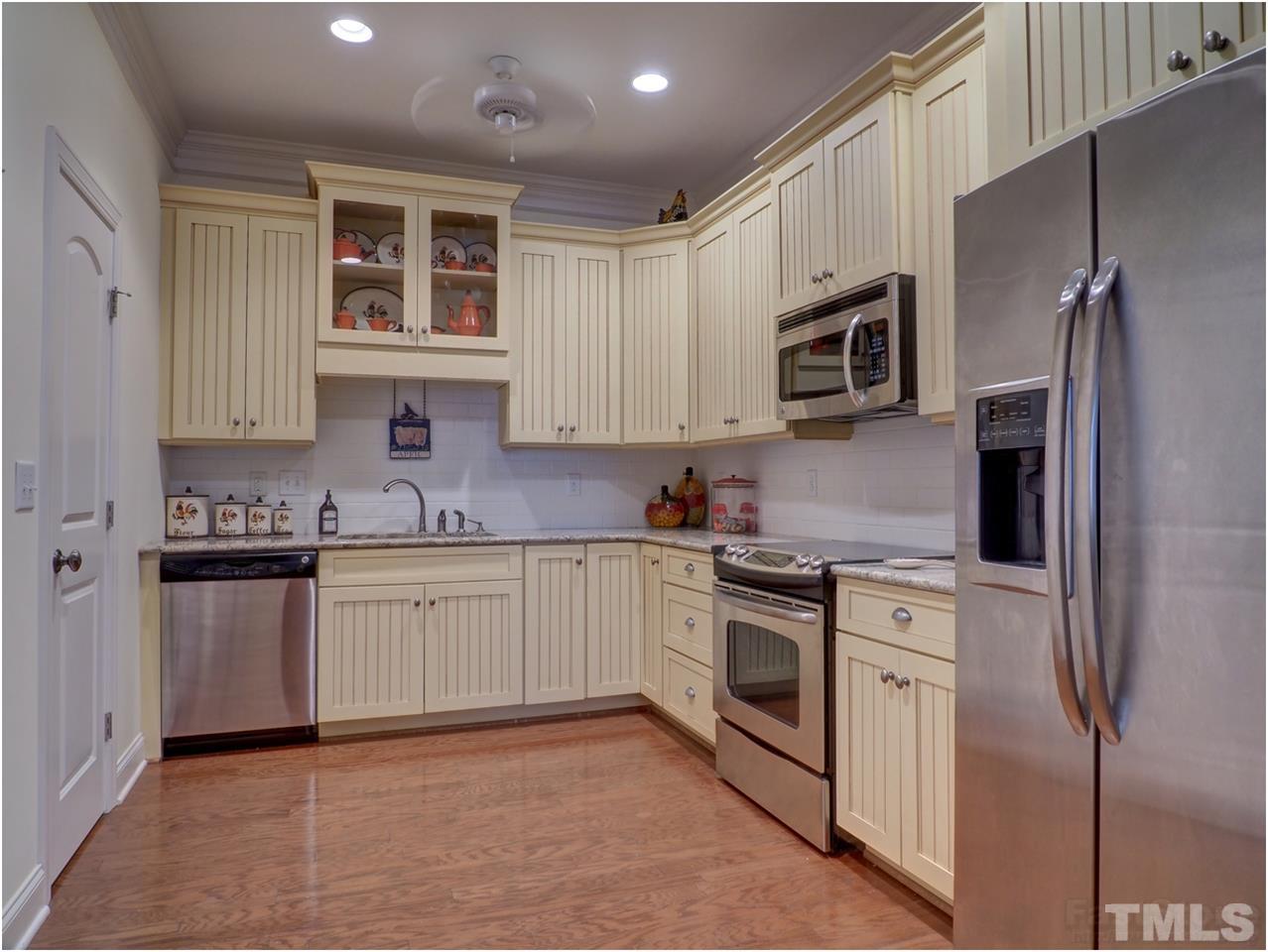 3408 Ocotea Street Raleigh, NC 27607 - Photo 21 of 25 a kitchen with granite countertop cabinets stainless steel appliances and a window