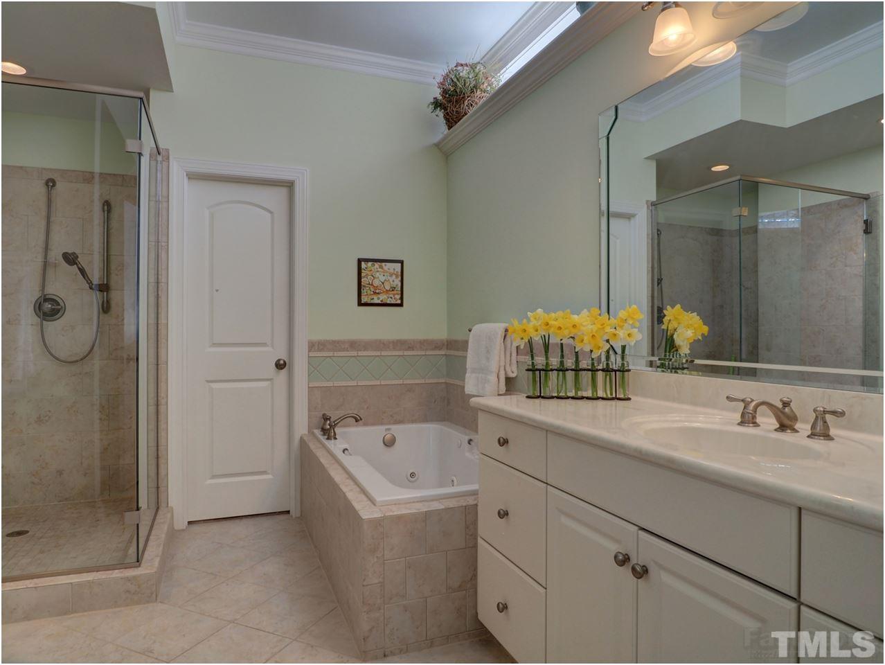 3408 Ocotea Street Raleigh, NC 27607 - Photo 23 of 25 a bathroom with a sink mirror and shower