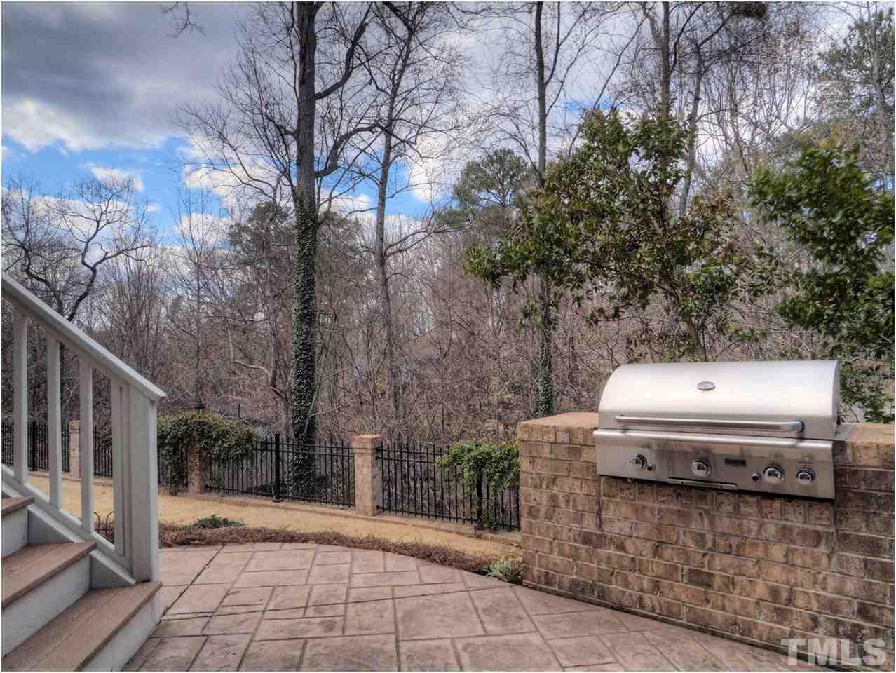 3408 Ocotea Street Raleigh, NC 27607 - Photo 25 of 25 a view of a yard with trees and buildings in the background