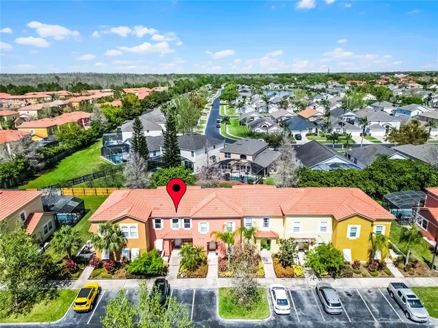 an aerial view of residential houses with outdoor space