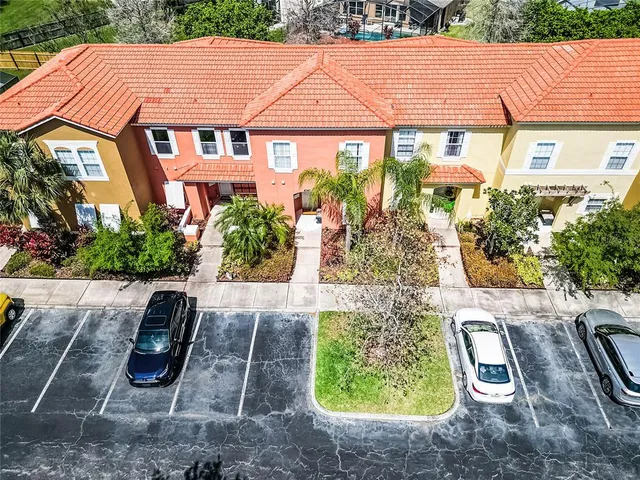 a view of a patio with couches table and chairs under an umbrella