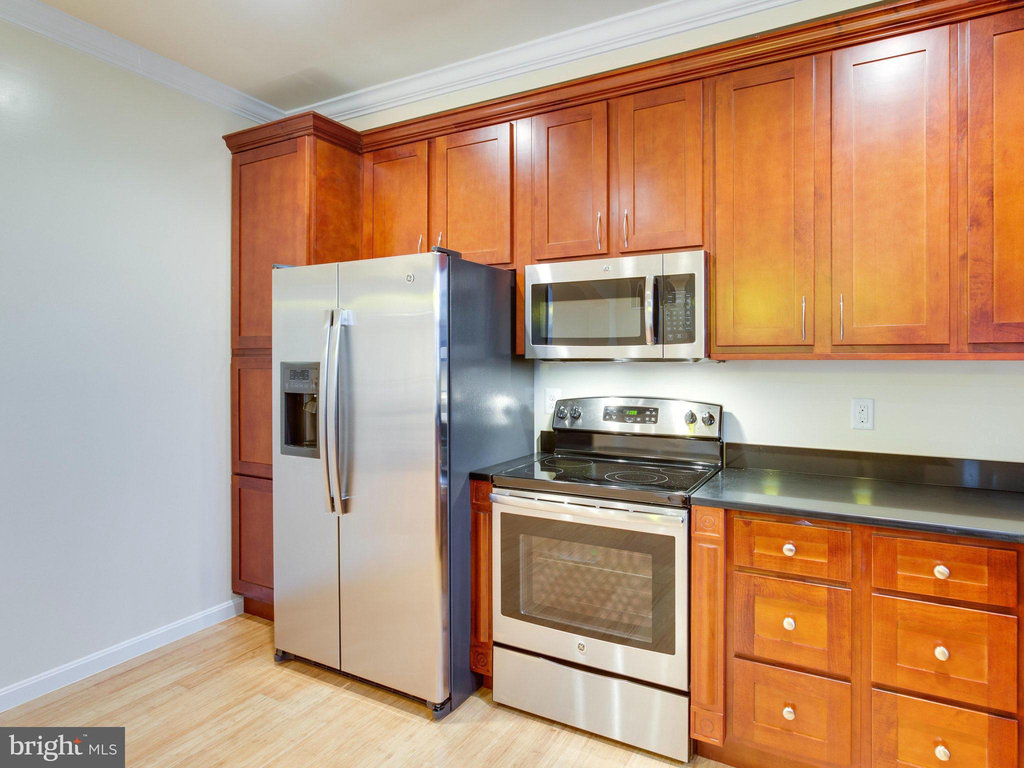 1778 W Street Southeast Washington, DC 20020 - Photo 3 of 16 a kitchen with granite countertop wooden cabinets and stainless steel appliances