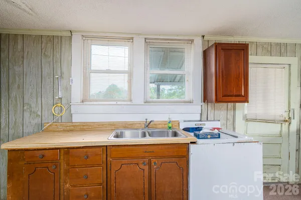 a kitchen with a sink cabinets and window