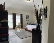 a bedroom with a bed and flat screen tv