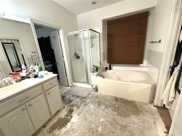 a bathroom with a bathtub sink and mirror