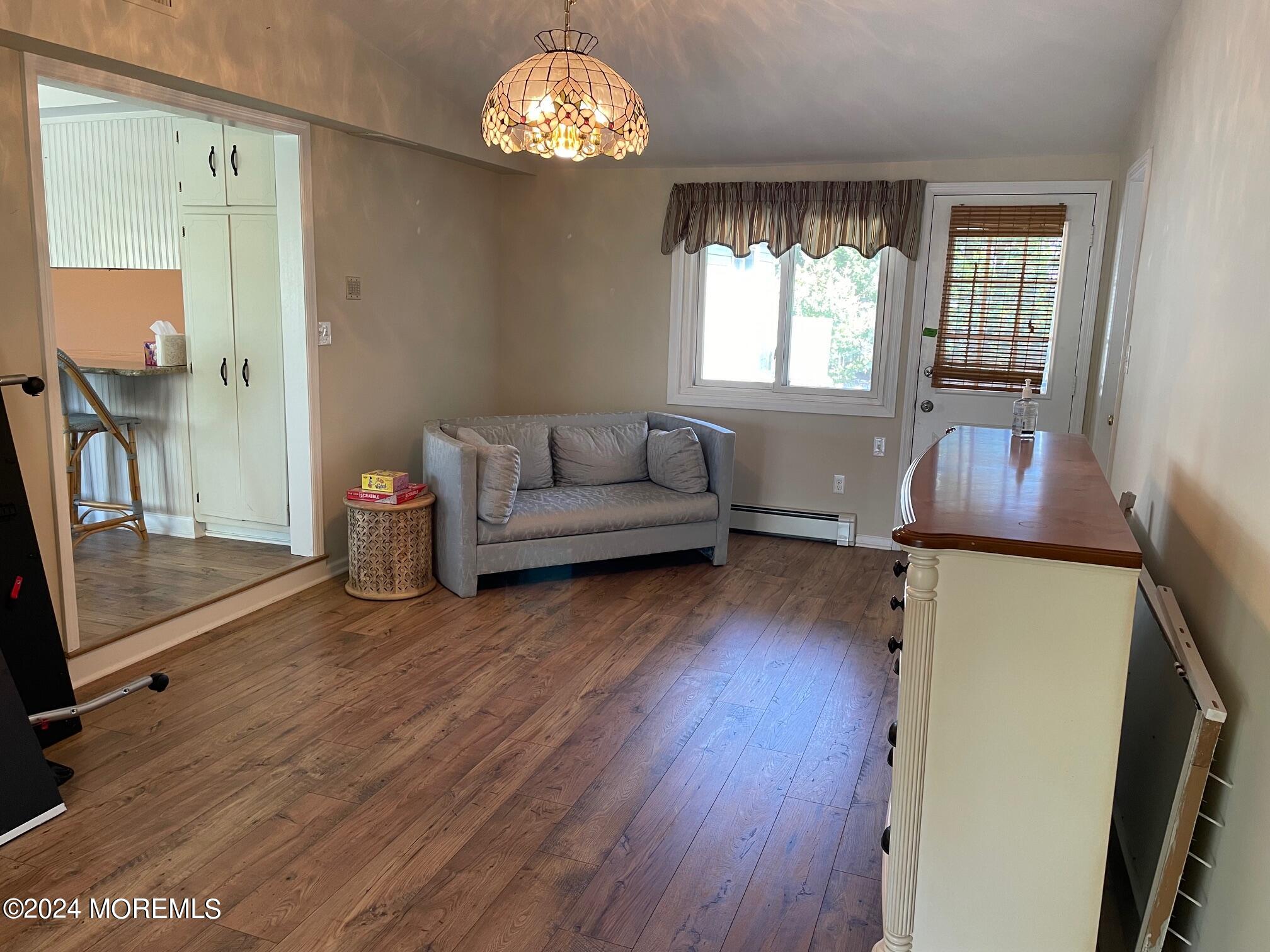 77 Jib Lane Brick, NJ 08723 - Photo 7 of 23 a living room with furniture and a chandelier