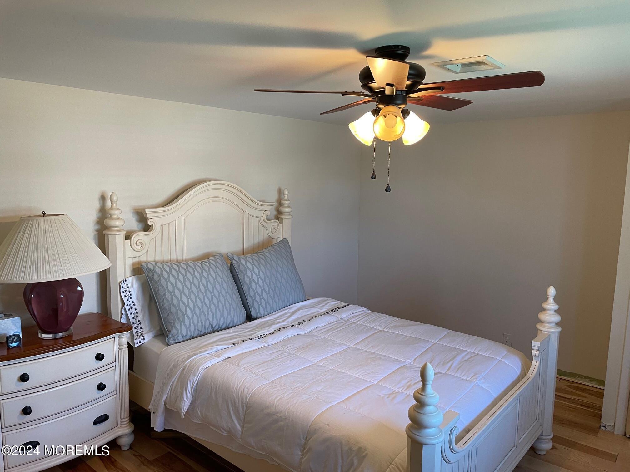 77 Jib Lane Brick, NJ 08723 - Photo 10 of 23 a bedroom with a bed and a chandelier