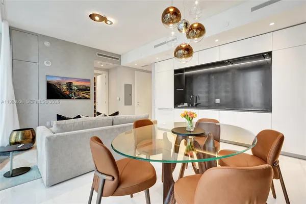 a dining room with furniture and wooden floor