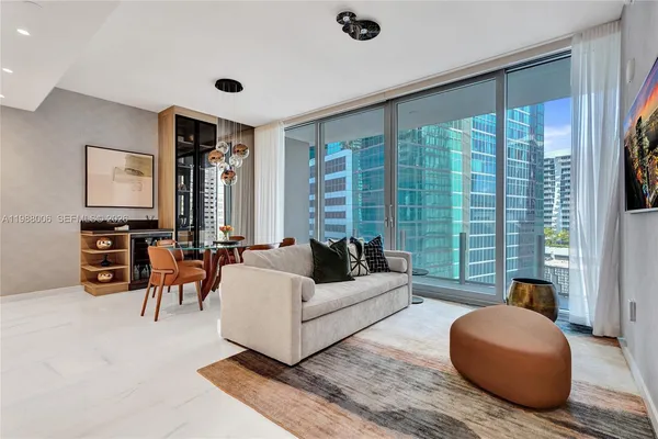 a living room with furniture and large windows