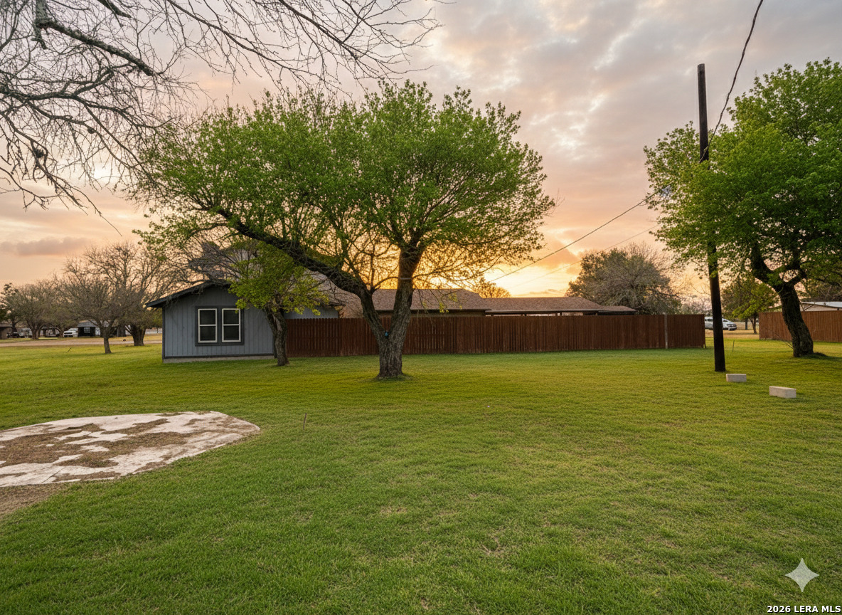 106 Adkins Road Refugio, TX 78377 - Photo 3 of 11 a view of a trees in a yard next to a house