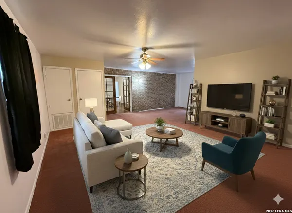 a living room with furniture and a flat screen tv