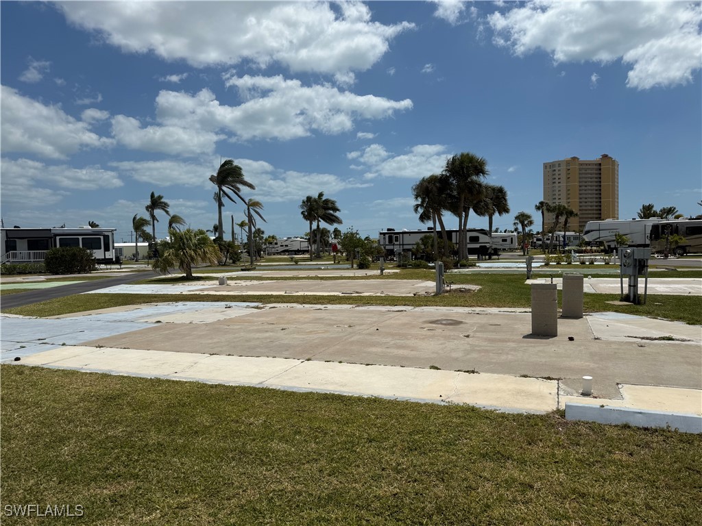 19681 Summerlin Road, Unit 527 Fort Myers, FL 33908 - Photo 4 of 10 a view of a swimming pool and a yard