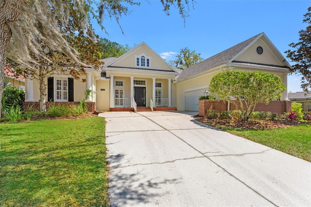 5748 Summit View Drive Brooksville, FL 34601 - Photo 1 of 1 a front view of a house with garden