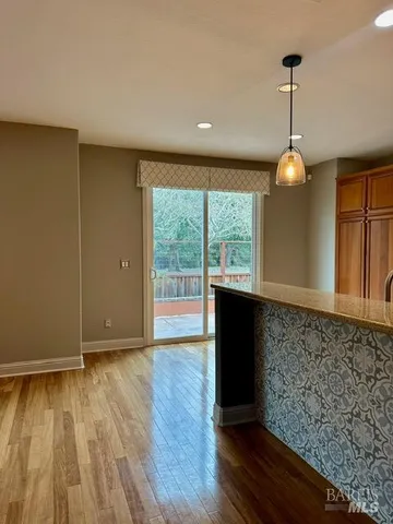 a view of a room with wooden floor and a large window