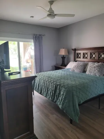 a bedroom with a bed and a flat screen tv