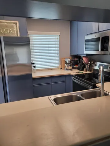 a kitchen with a sink and a stove top oven