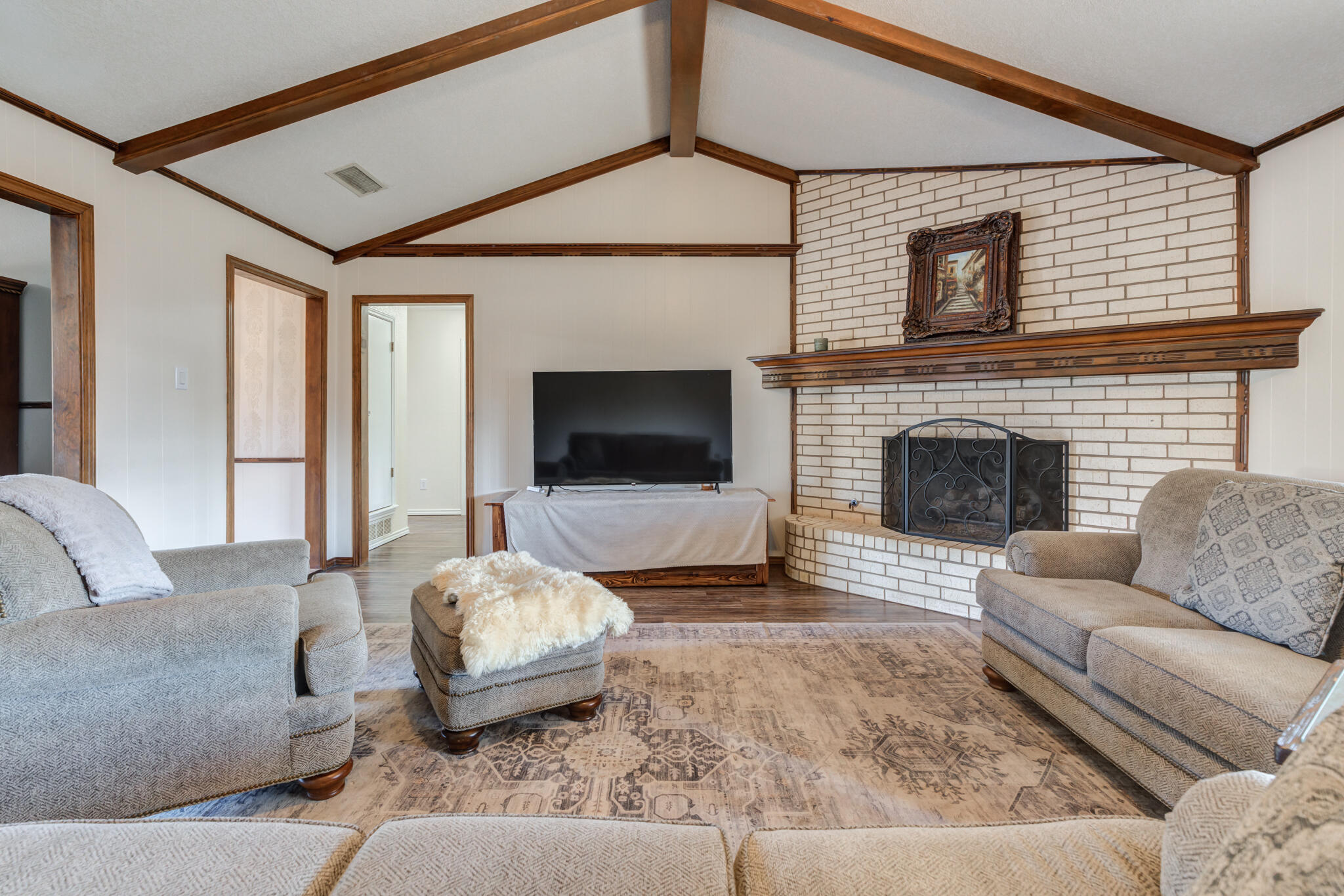5703 80th Street Lubbock, TX 79424 - Photo 15 of 45 a living room with furniture and a fireplace