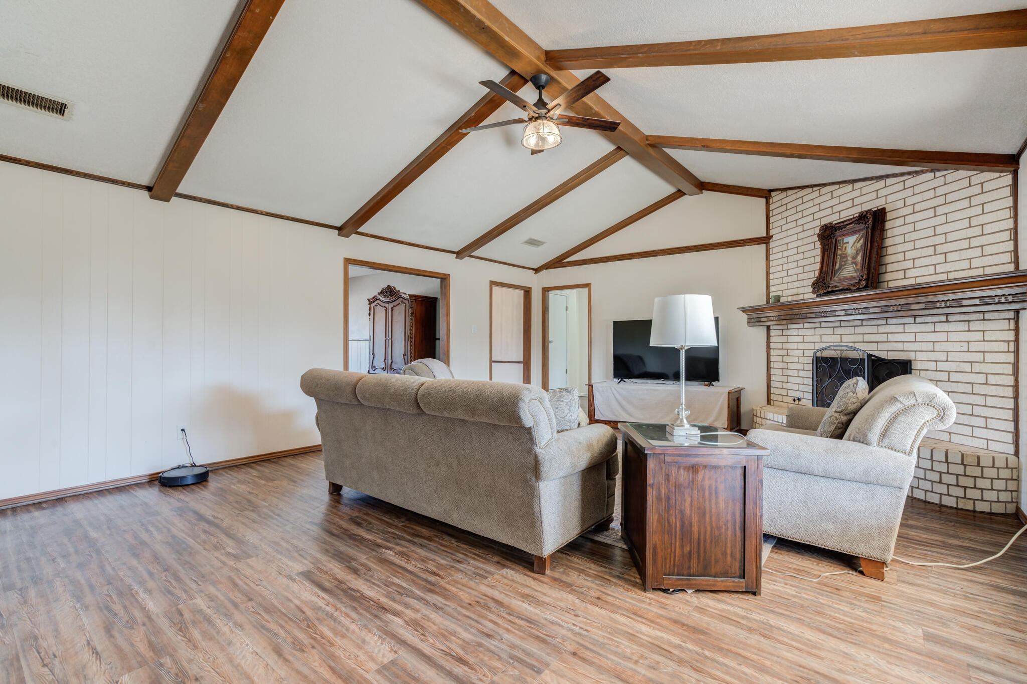 5703 80th Street Lubbock, TX 79424 - Photo 17 of 45 a living room with furniture and a fireplace