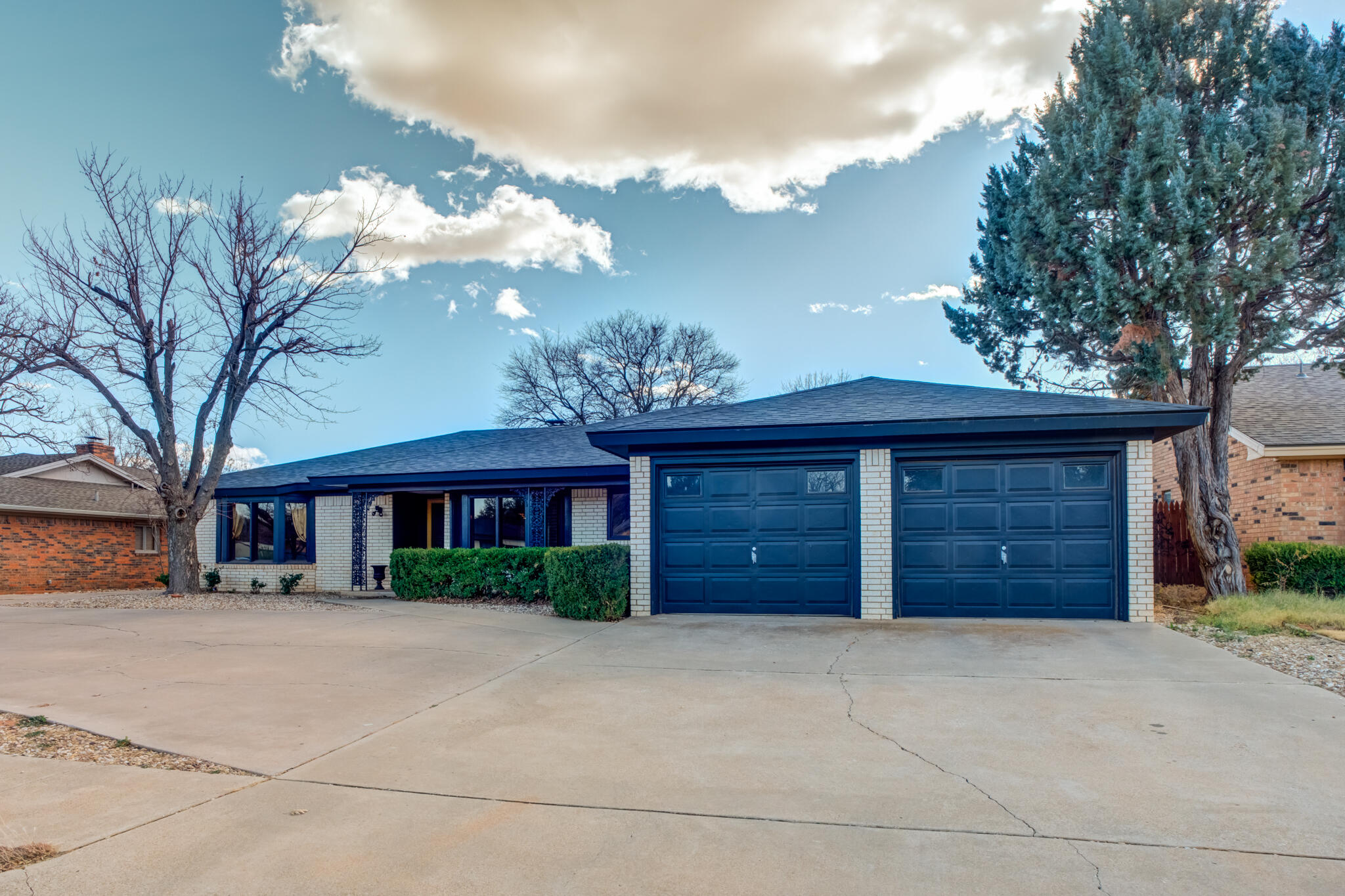 5703 80th Street Lubbock, TX 79424 - Photo 2 of 45 a view of a house with a yard and garage