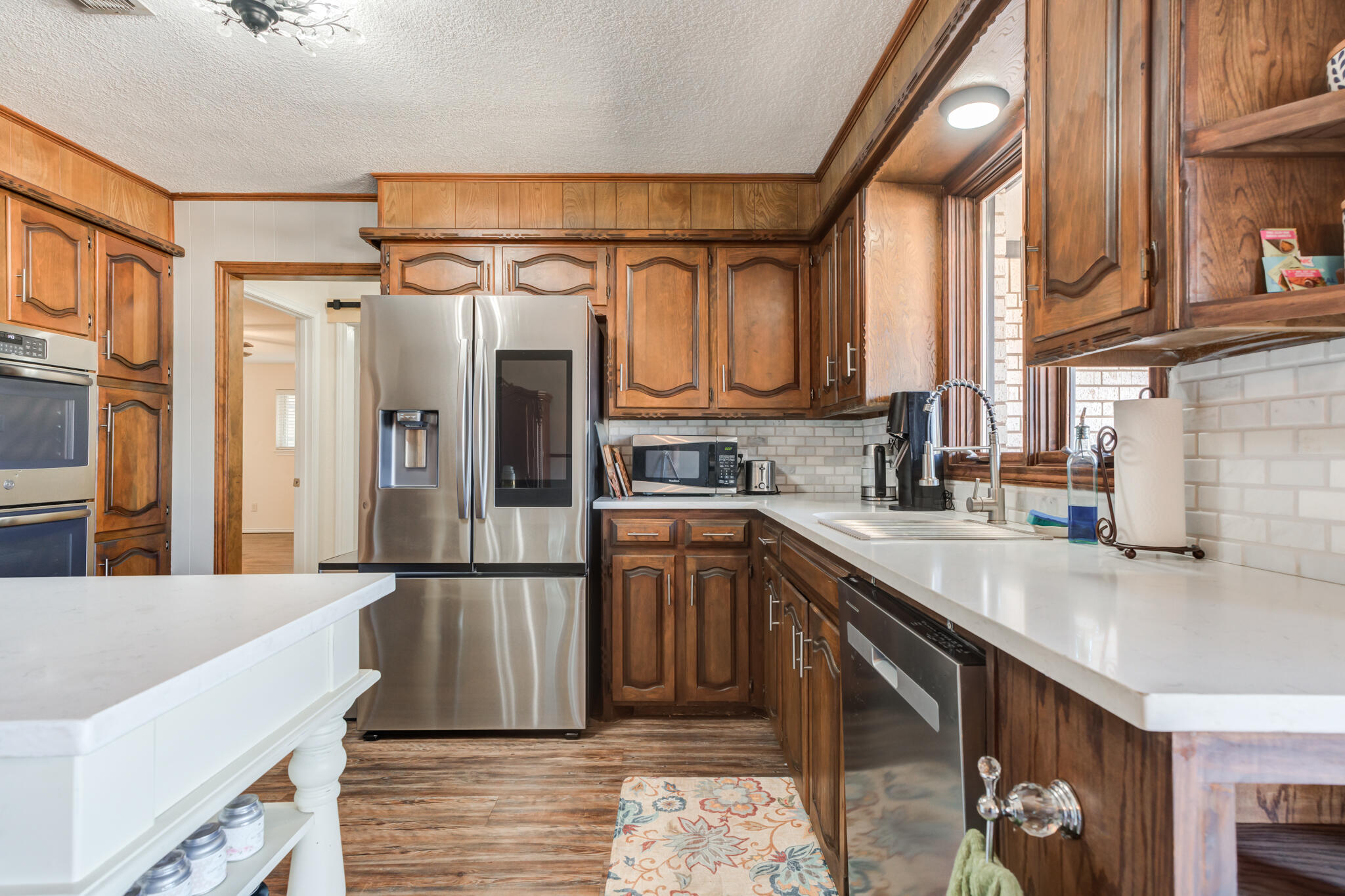 5703 80th Street Lubbock, TX 79424 - Photo 22 of 45 a kitchen with stainless steel appliances granite countertop a refrigerator and a sink