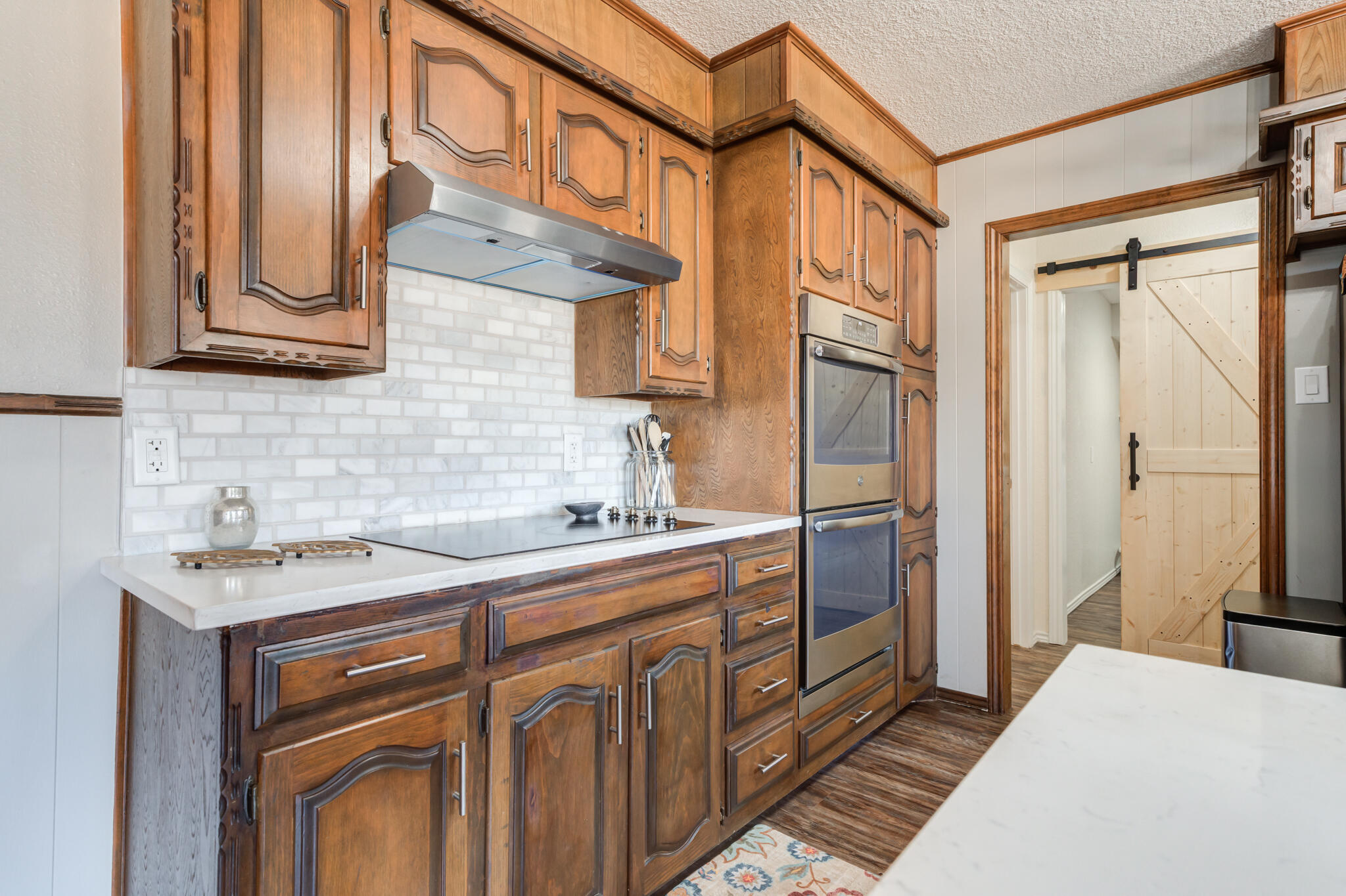 5703 80th Street Lubbock, TX 79424 - Photo 23 of 45 a kitchen with stainless steel appliances granite countertop a refrigerator a sink dishwasher and wooden cabinets with wooden floor