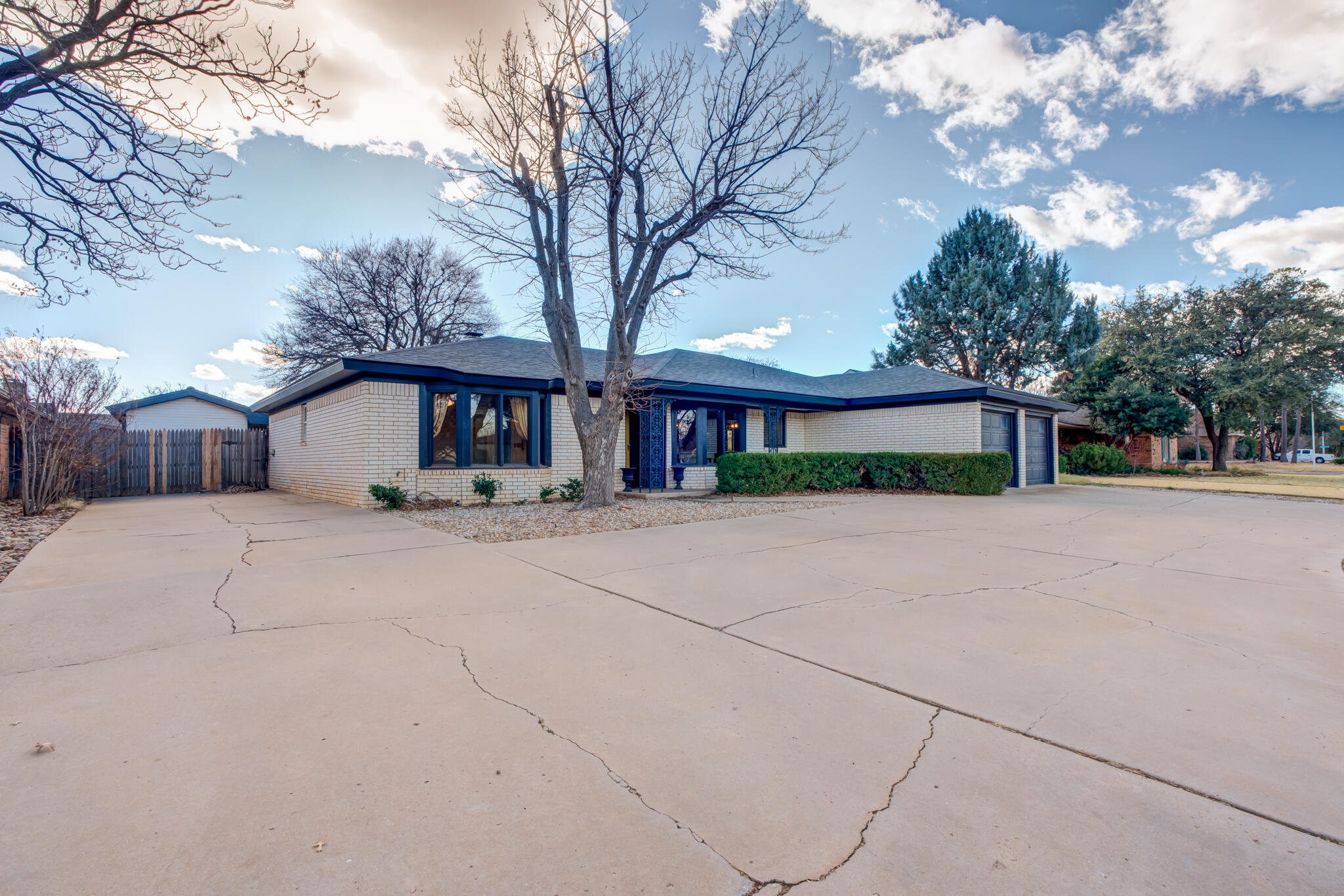 5703 80th Street Lubbock, TX 79424 - Photo 3 of 45 a front view of a house with a yard and garage