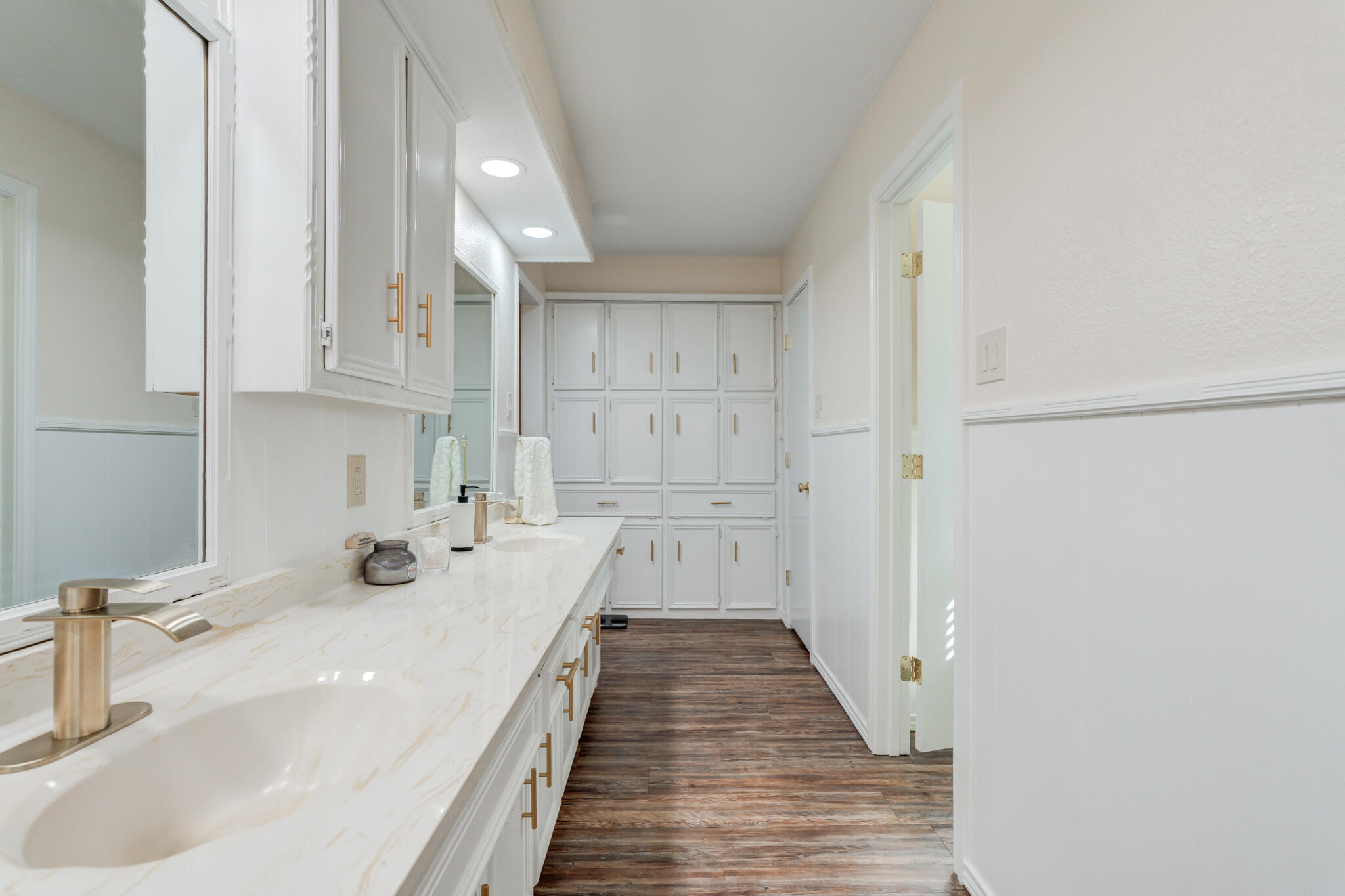 5703 80th Street Lubbock, TX 79424 - Photo 36 of 45 a bathroom with a sink and a large mirror
