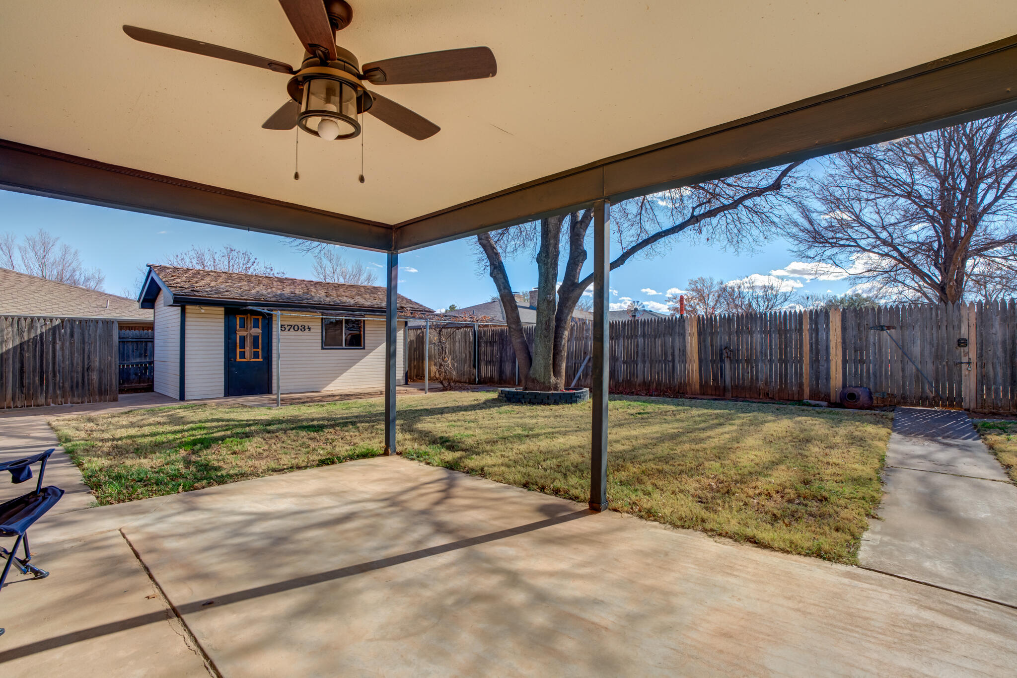 5703 80th Street Lubbock, TX 79424 - Photo 38 of 45 a view of a house with backyard and a tree