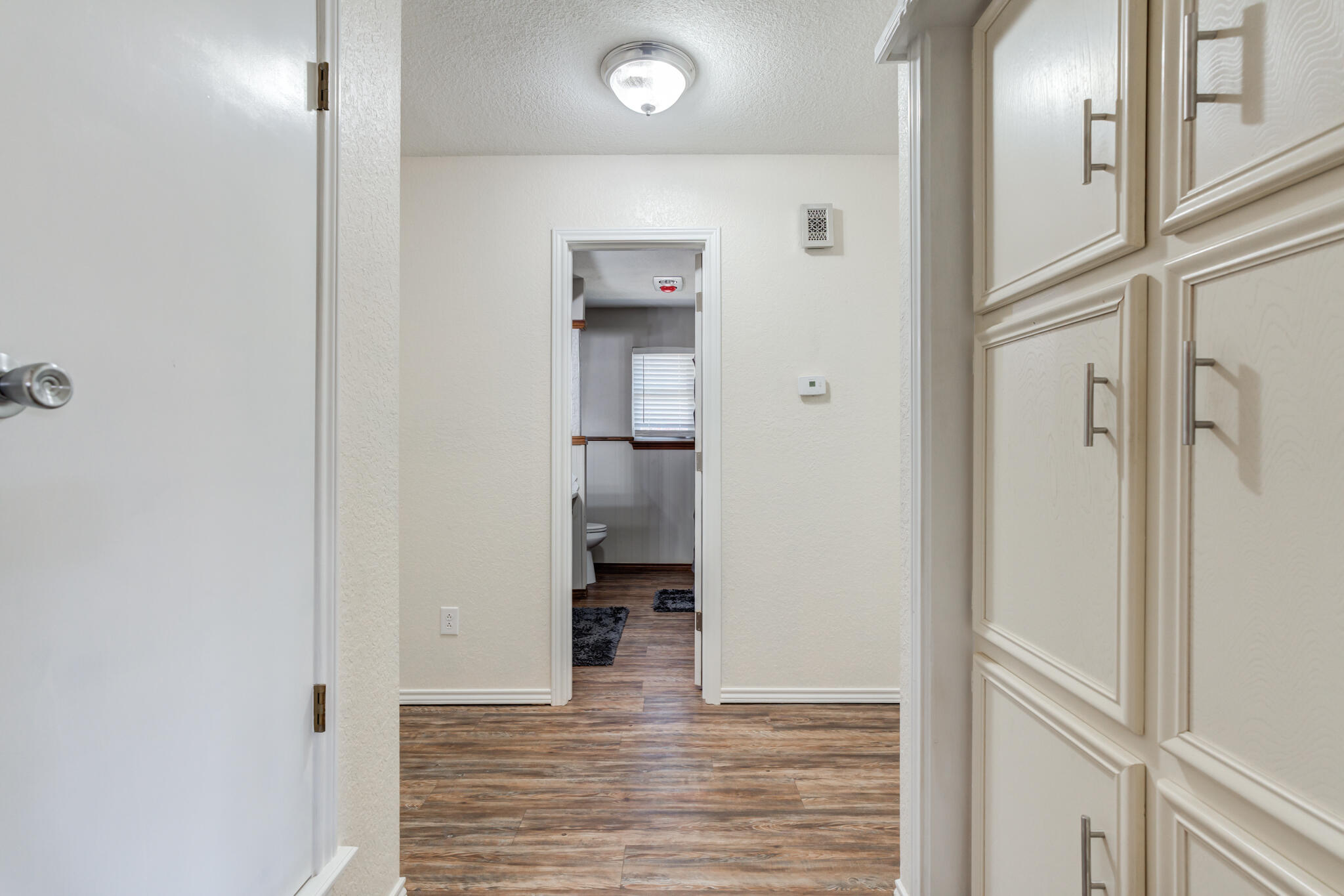 5703 80th Street Lubbock, TX 79424 - Photo 6 of 45 a view of a hallway with wooden floor and staircase