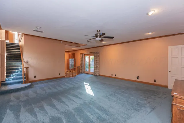 a view of an empty room with a fireplace and a large window