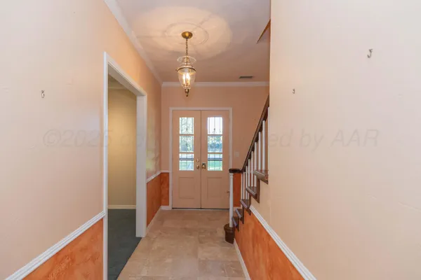 a view of hallway with stairs and wooden floor